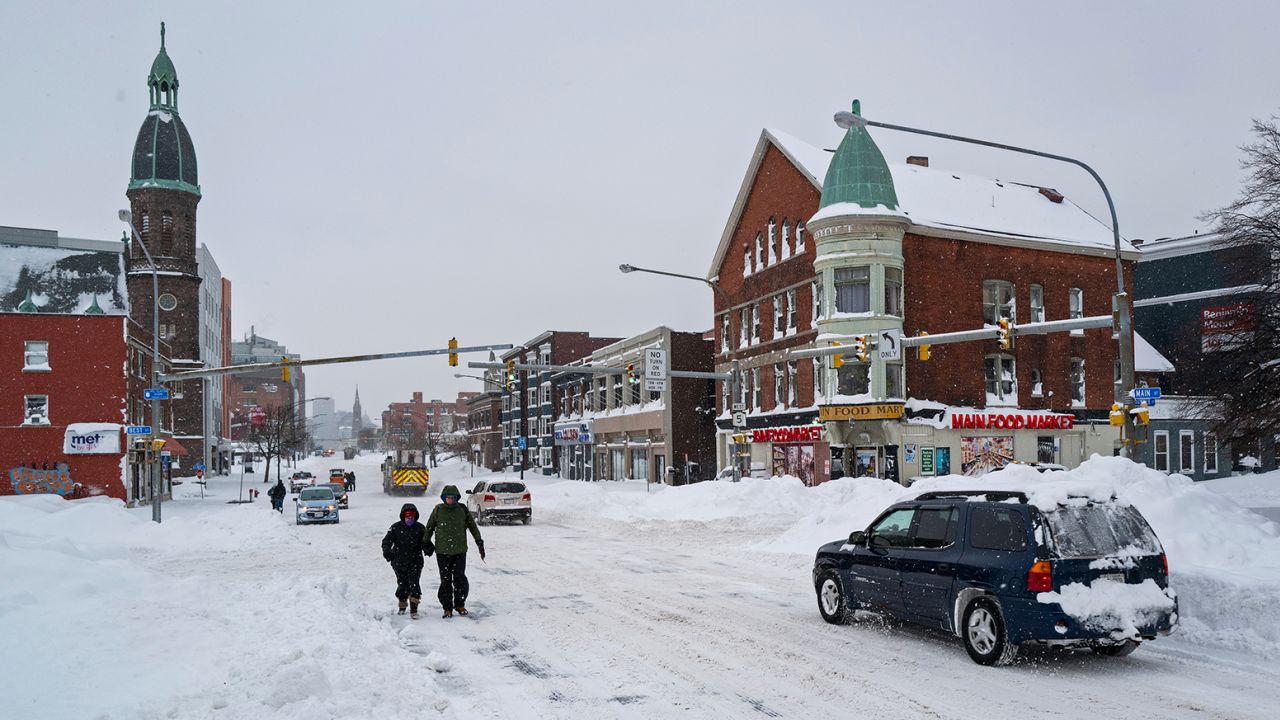 People and vehicles move about Monday on Main Street in Buffalo.
