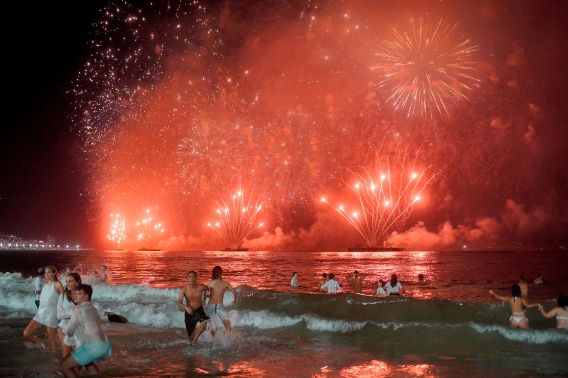 Despite Covide restrictions limiting the celebrations, some revellers still watched the fireworks on Copacabana Beach in Rio de Janeiro last year.