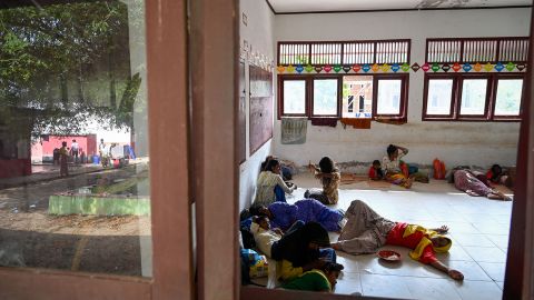 Rohingya refugees rest after being transferred to a temporary shelter following their arrival by a boat in Laweung, Aceh province on December 27, 2022.