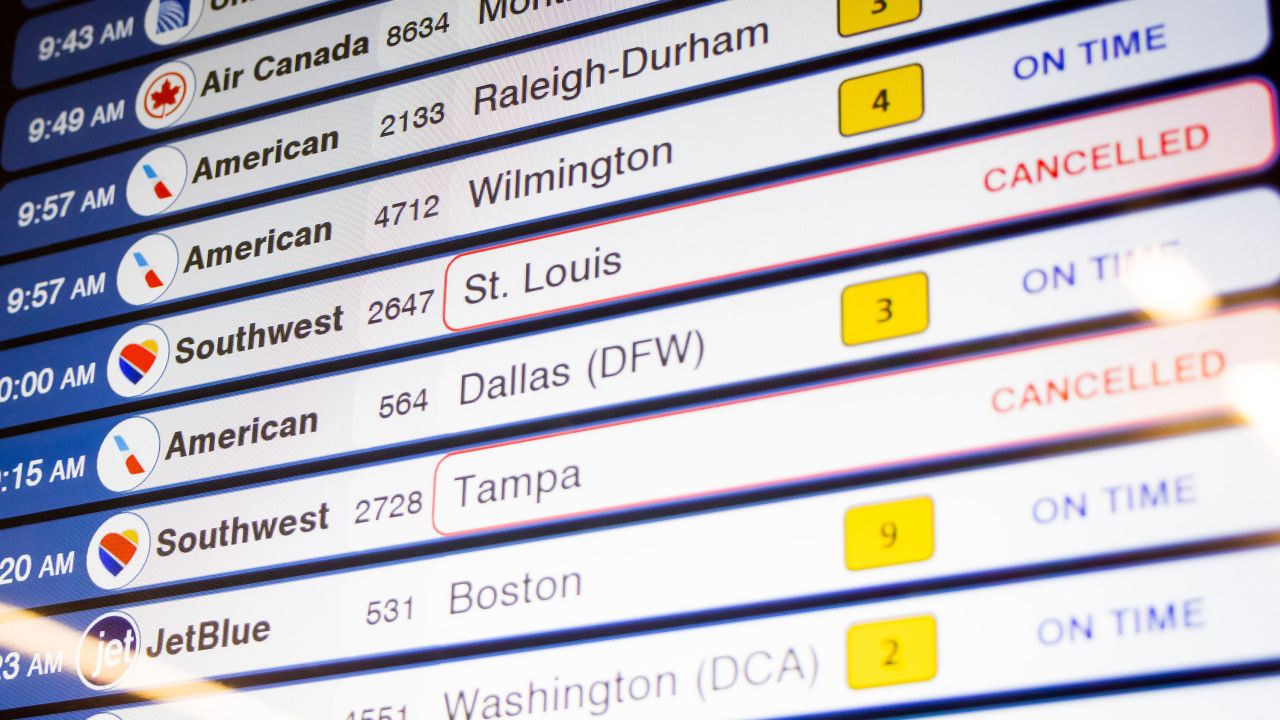 Cancelled Southwest Airlines flights are seen on the flight schedules at LaGuardia Airport, Tuesday, Dec. 27, 2022, in New York. The U.S. Department of Transportation says it will look into flight cancellations by Southwest that have left travelers stranded at airports across the country amid an intense winter storm.   (AP Photo/Yuki Iwamura)