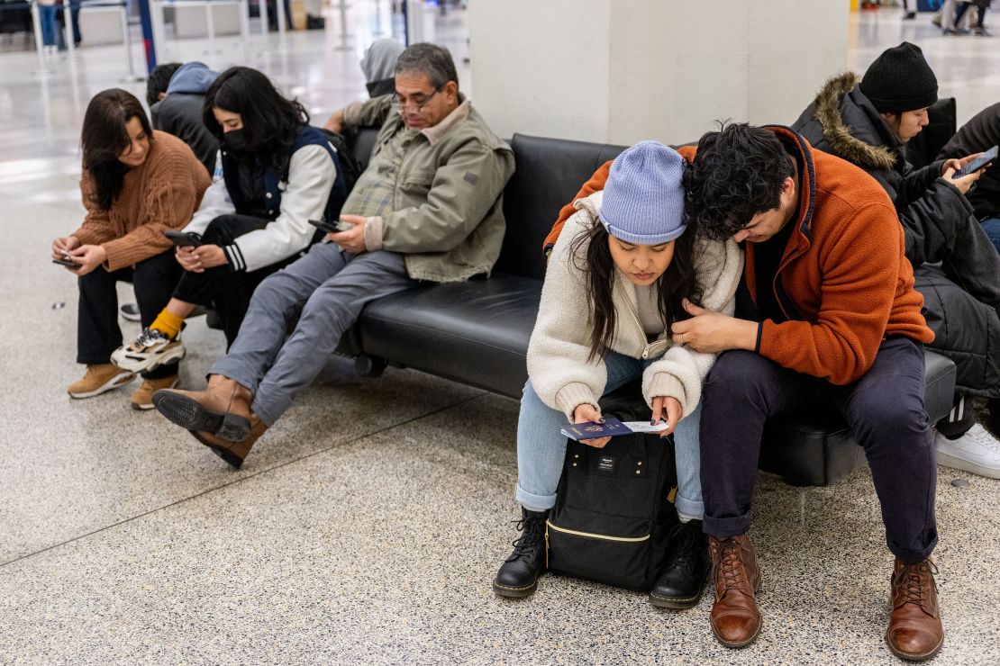 Travelers wait at George Bush Intercontinental Airport on December 27, 2022, in Houston, Texas, after Southwest canceled approximately 5,400 flights in less than 48 hours.
