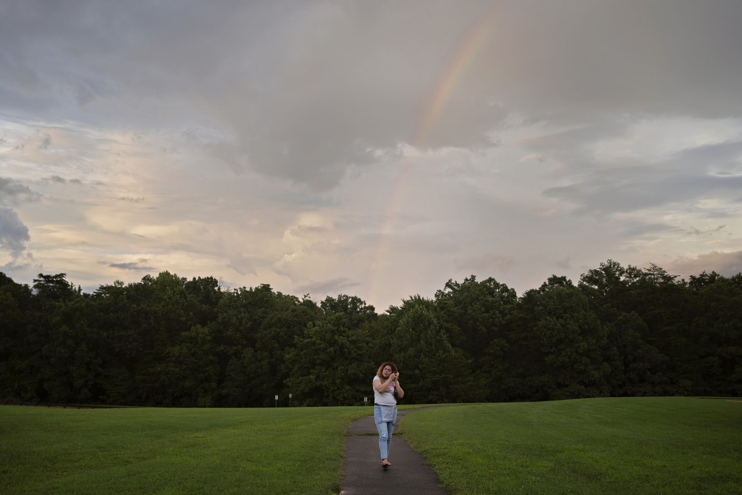 After a rain in Virginia, Kataleya Nativi Baca walks beneath a rainbow.