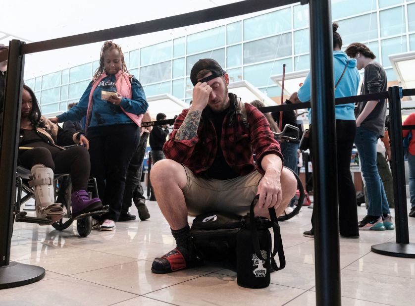 Travelers at Baltimore/Washington International Airport deal with the impact of canceled flights on December 27.