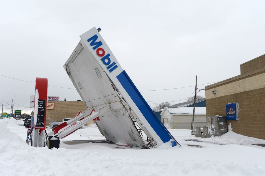 A gas station canopy lays on its side after high winds and heavy snow in Lackawanna, New York, on December 27. The historic winter storm dumped up to 4 feet of snow on the area.