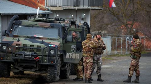 NATO peacekeepers stand guard at a roadblock in Rudare, near the northern part of of Mitrovica.