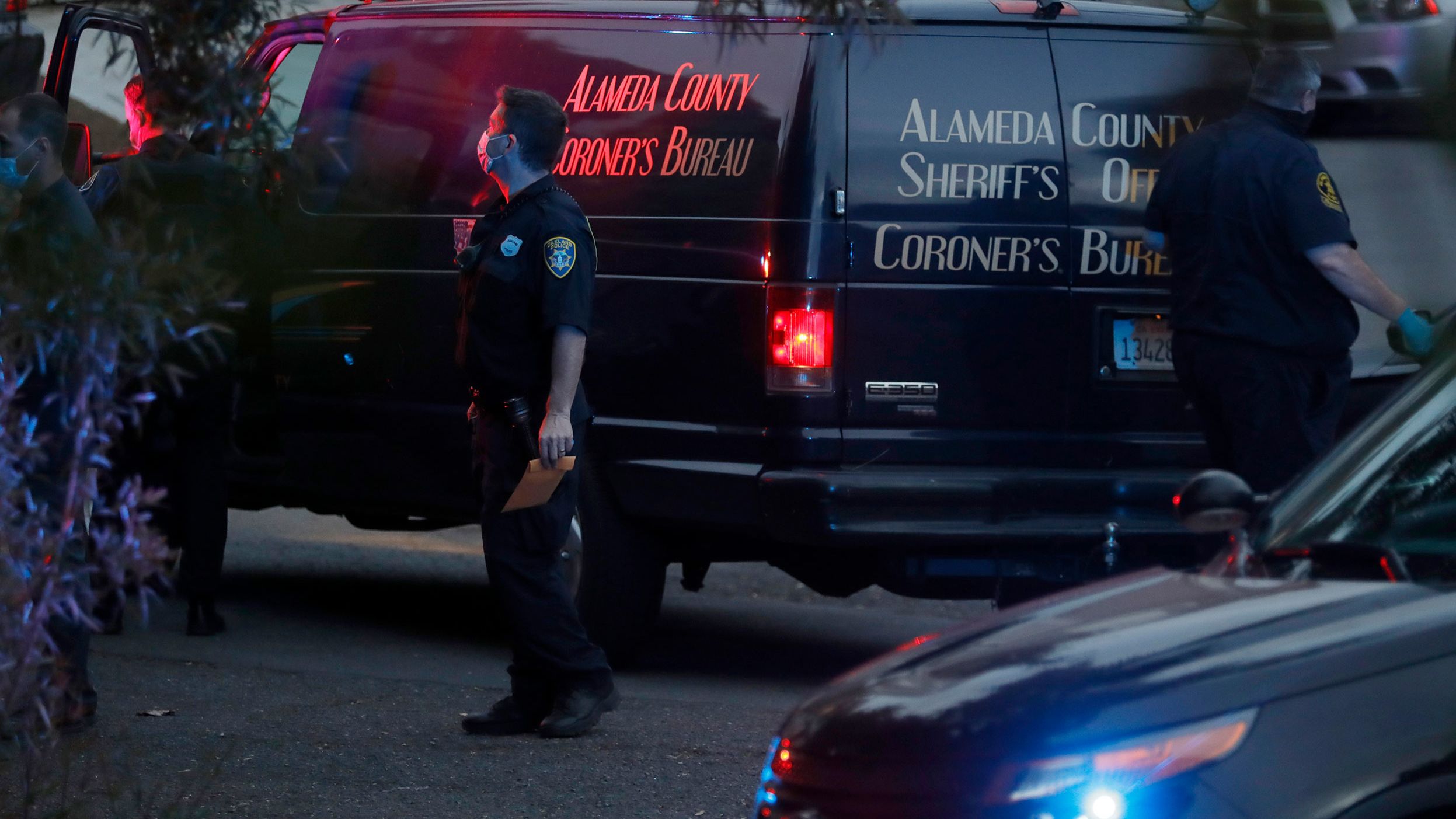 Deputies from the coroner's bureau of the Alameda County Sheriff's Office work a crime scene in Oakland, California, on May 16, 2021.
