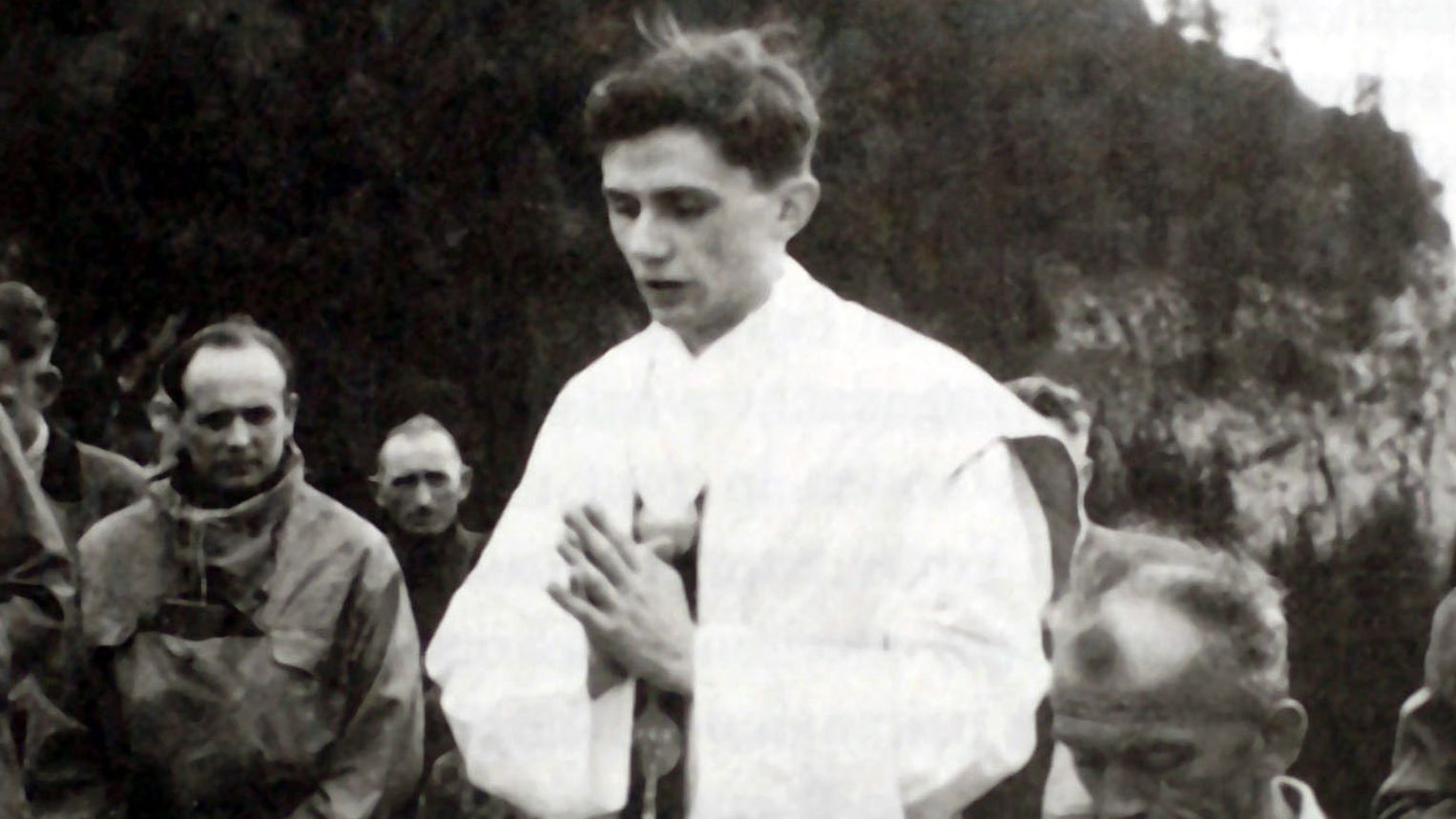Benedict, center, prays during an open-air Mass near Ruhpolding, Germany, in 1952. He was ordained as a priest in 1951.