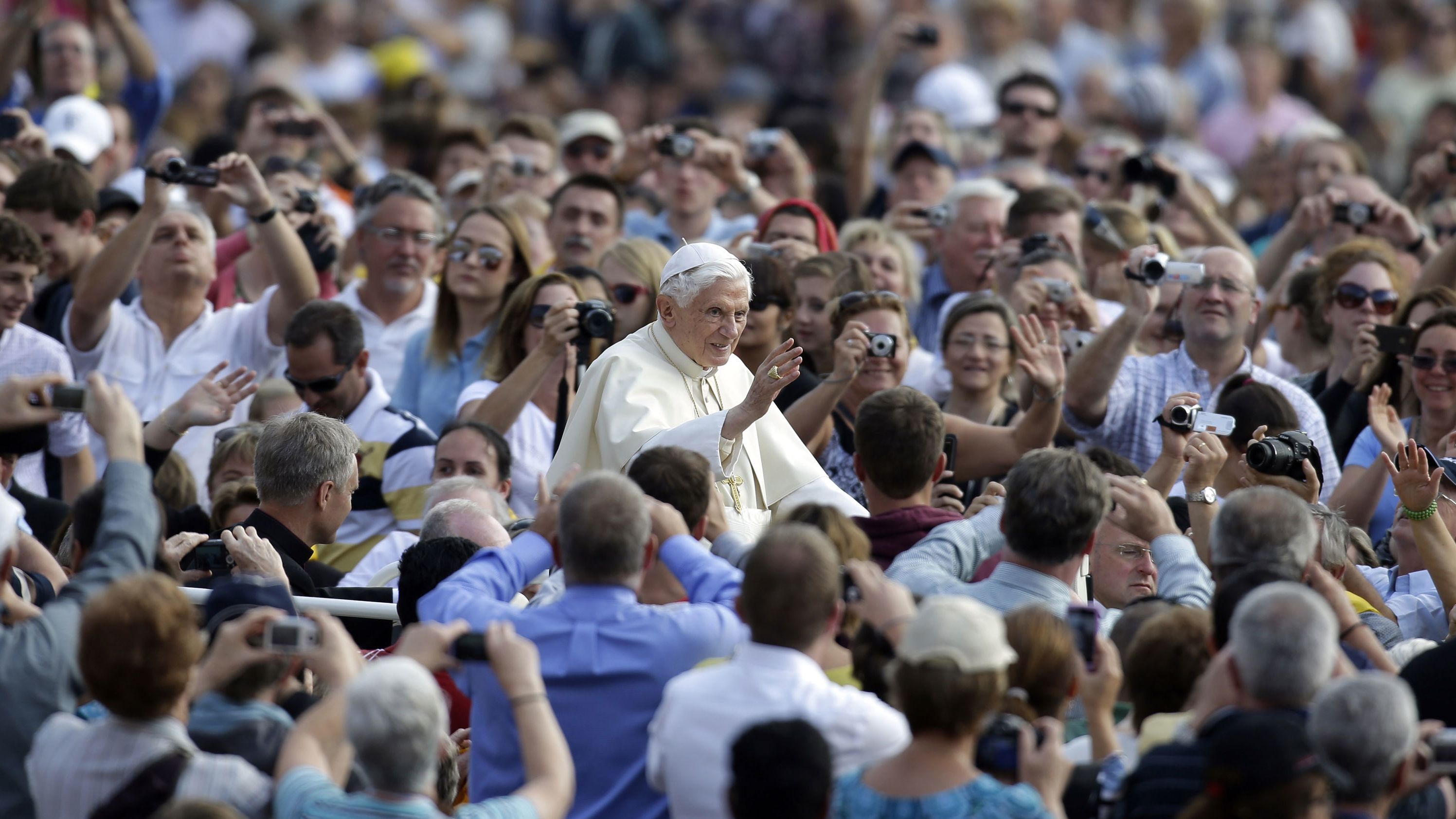 Benedict delivers his blessing as he is driven through the crowd in St. Peter's Square in October 2012.