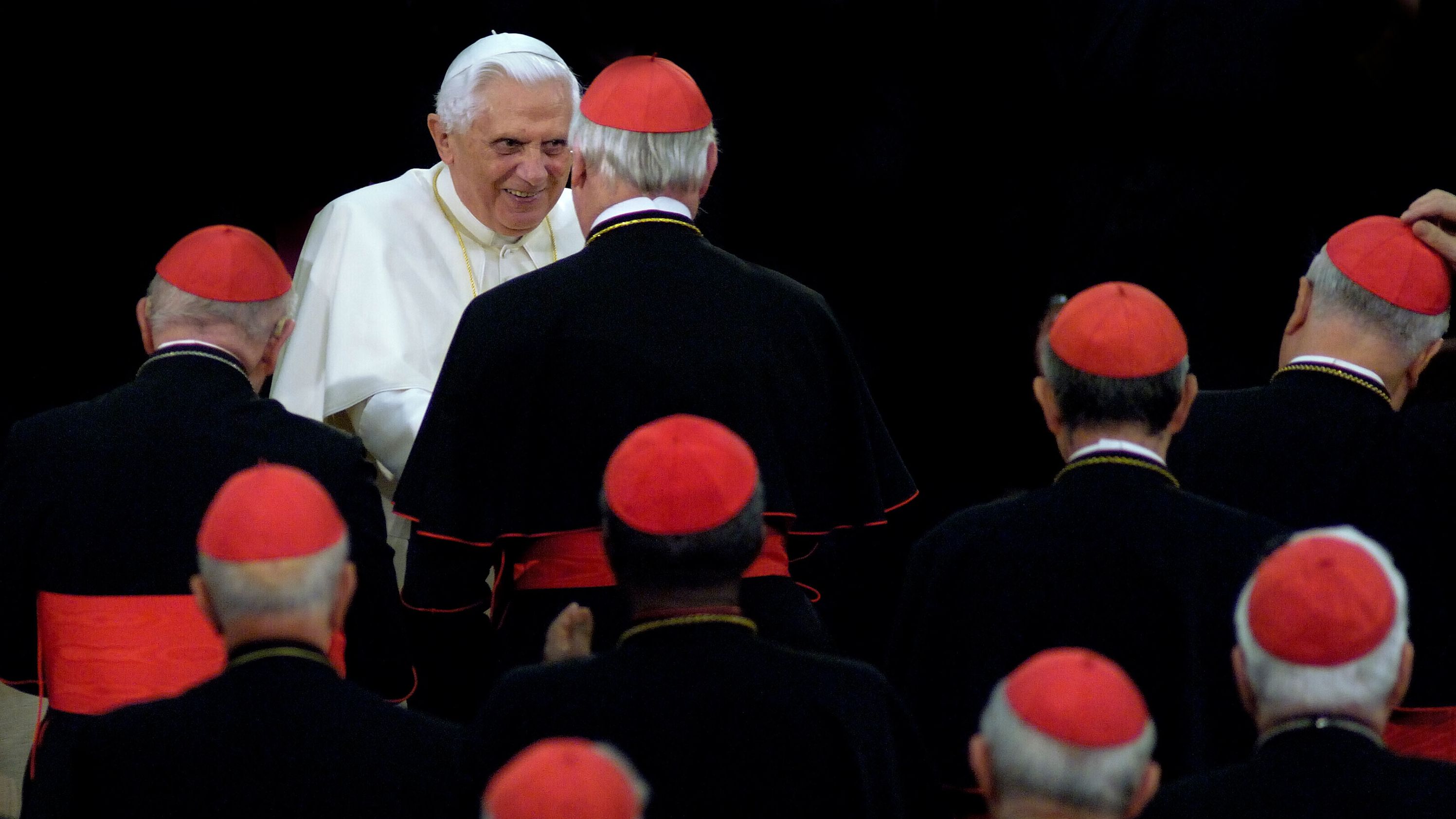 Benedict is greeted by cardinals as he arrives to attend a concert at the Vatican in October 2007.