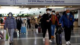 Travellers walk with their luggage at Beijing Capital International Airport, amid the coronavirus disease (COVID-19) outbreak in Beijing, China December 27, 2022. REUTERS/Tingshu Wang