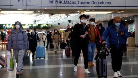 Travellers walk with their luggage at Beijing Capital International Airport in Beijing, China December 27, 2022.