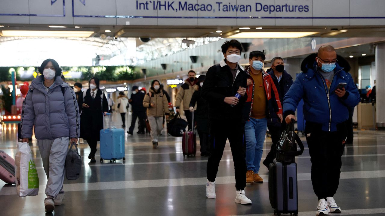 Travelers walk with their luggage at Beijing Capital International Airport, amid the coronavirus disease (COVID-19) outbreak in Beijing, China December 27, 2022. REUTERS/Tingshu Wang