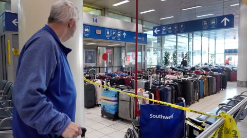 A traveler checks baggage in baggage claim in the Southwest Airlines terminal at St. Louis Lambert International Airport on Wednesday.