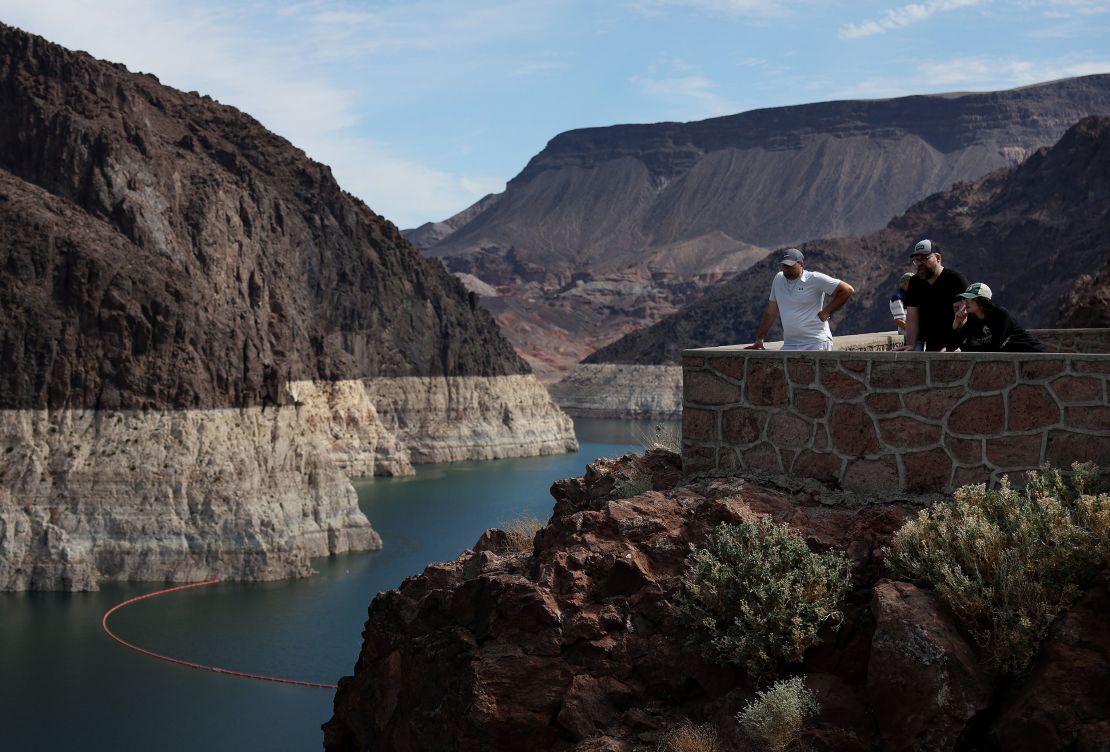 Park visitors look at the "bathtub ring" visible on the banks of Lake Mead near the Hoover Dam in August. The ring shows how much the reservoir has fallen from its normal level.
