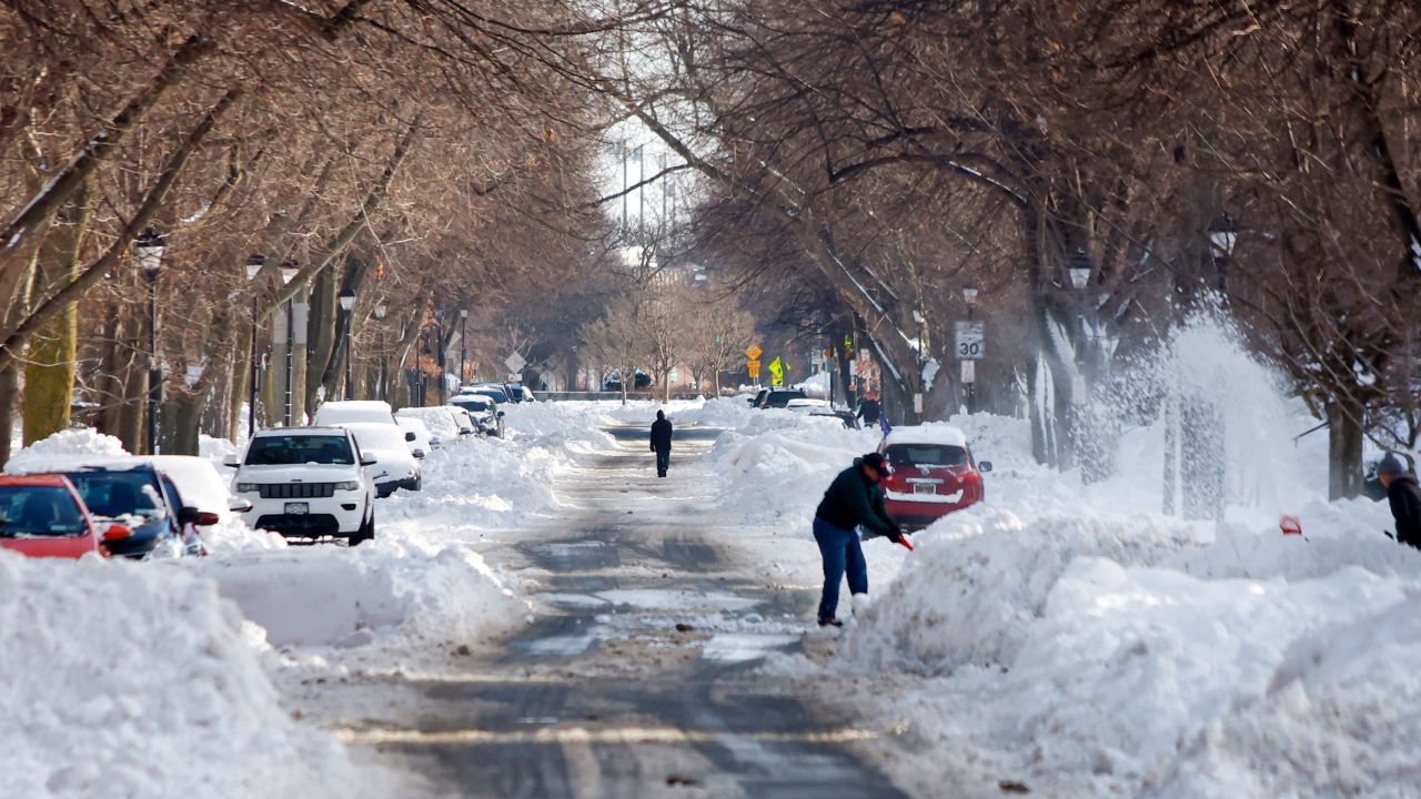 A person clears snow along a Buffalo road on Wednesday, December 28.