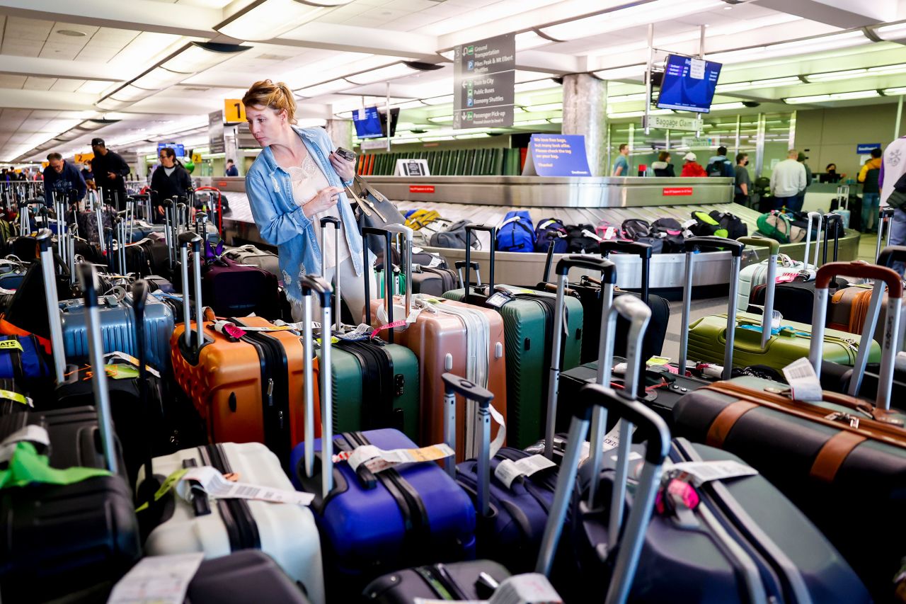 A traveler searches for luggage December 28 at a Southwest Airlines baggage holding area in Denver International Airport. More than 90% of Wednesday's US flight cancellations were Southwest flights, according to flight tracking website FlightAware. Southwest canceled more than 2,500 flights.