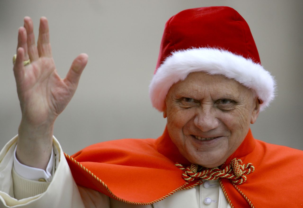 Benedict wears a fur-trimmed Santa-like hat as he waves to pilgrims in St. Peter's Square in December 2005 The red hat with white fur is known in Italian as the "camauro." It was popular among pontiffs in the 17th century.