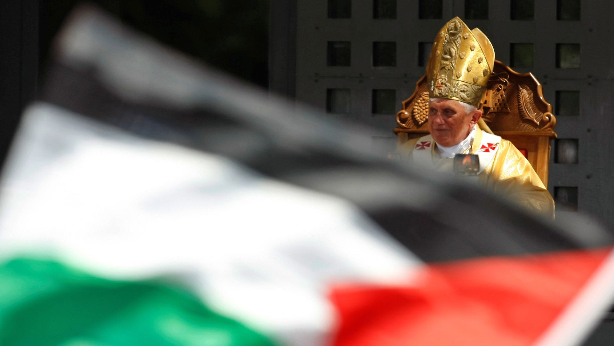 The Pope leads a mass in Manger Square, next to the Church of the Nativity, as a Palestinian flag is waved the West Bank town of Bethlehem in May 2009.