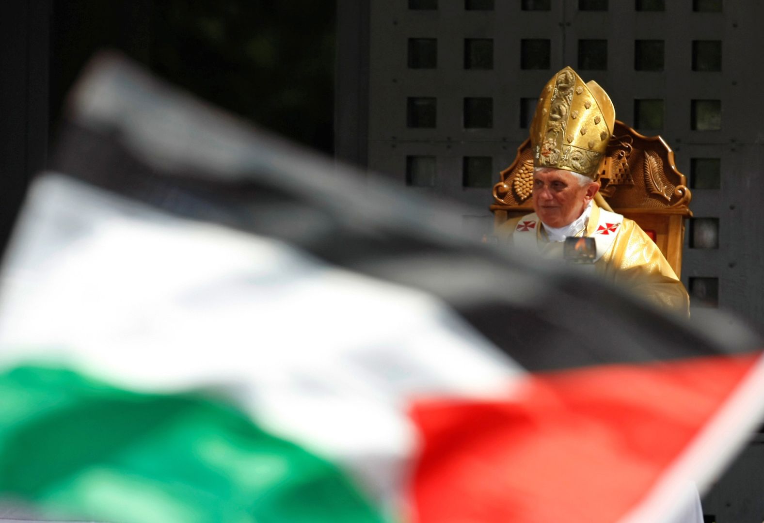 The Pope leads a mass in Manger Square, next to the Church of the Nativity, as a Palestinian flag is waved the West Bank town of Bethlehem in May 2009.