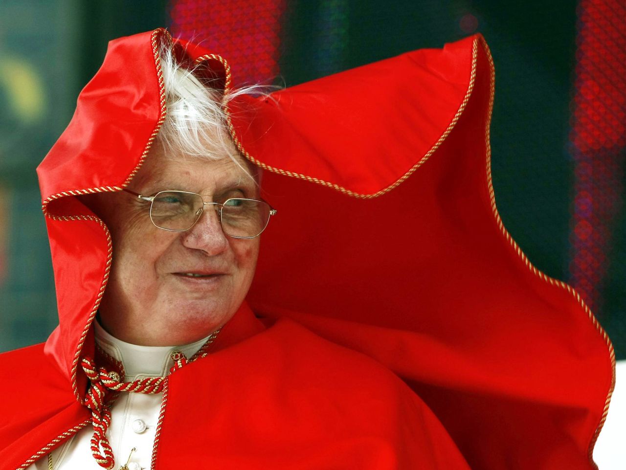 A gust of wind blows the Pope's coat over his head while visiting Vienna, Austria, in September 2007.