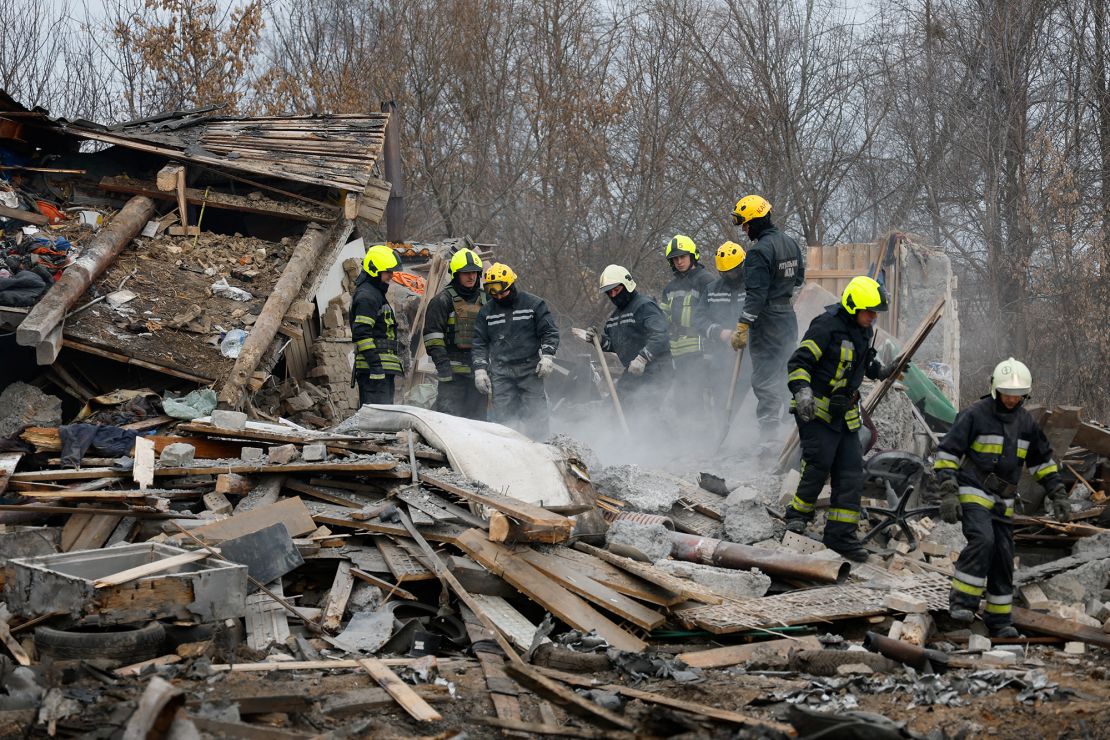 Rescuers dig through the rubble of a house hit by a Russian missile strike.