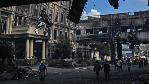 People walk near the destroyed part of the hotel casino on Thursday.