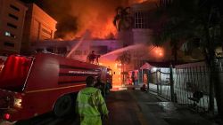 This pictures taken between December 28 and 29, shows firefighters trying to douse a fire at the Grand Diamond City Hotel and Casino in Poipet, Cambodia.