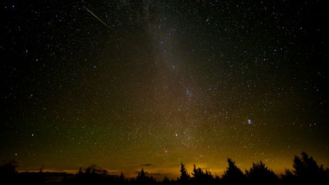 A meteor streaks across the sky during the Perseid meteor shower in August 2016 above Spruce Knob in West Virginia. 