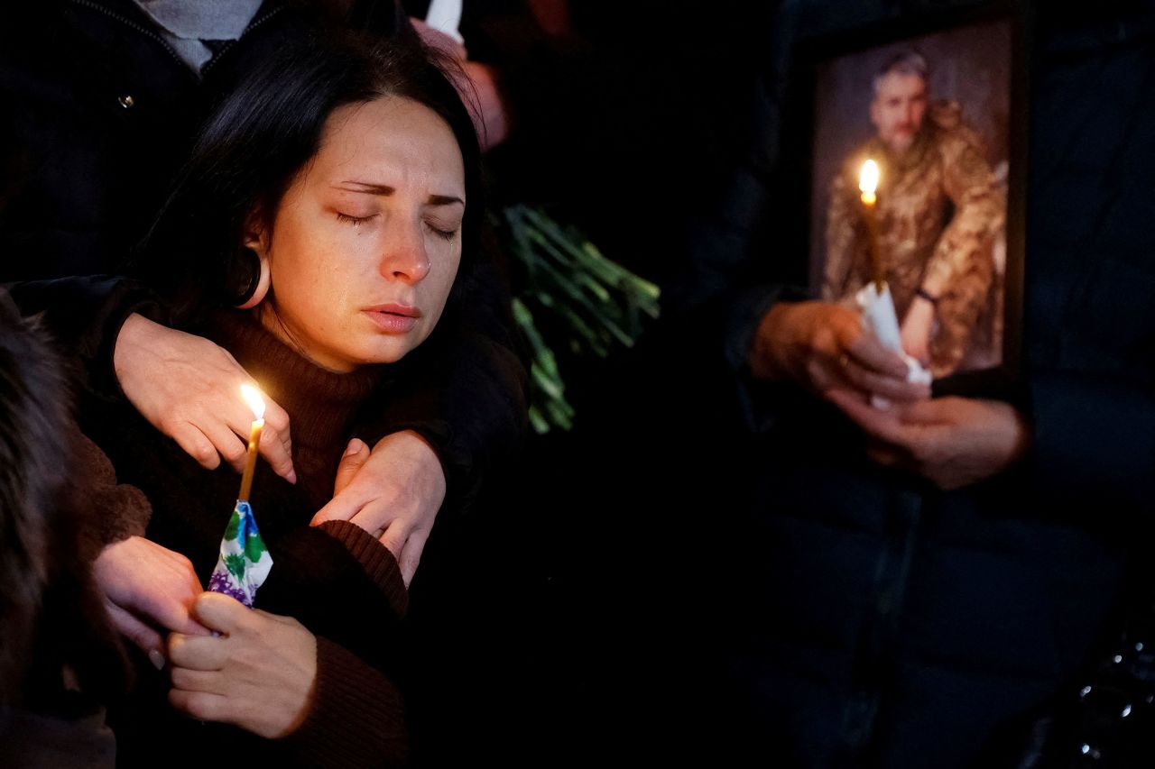 A woman named Olha reacts during a funeral ceremony held for her husband, Volodymyr Yezhov, in Kyiv, Ukraine, on Tuesday, December 27. Yezhov was killed in a battle with Russian troops near the town of Bakhmut, Ukraine.