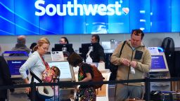 Travelers tag their bags at a Southwest Airlines ticket counter during the busy Christmas holiday season at Orlando International Airport on December 28, 2022 in Orlando, Florida.