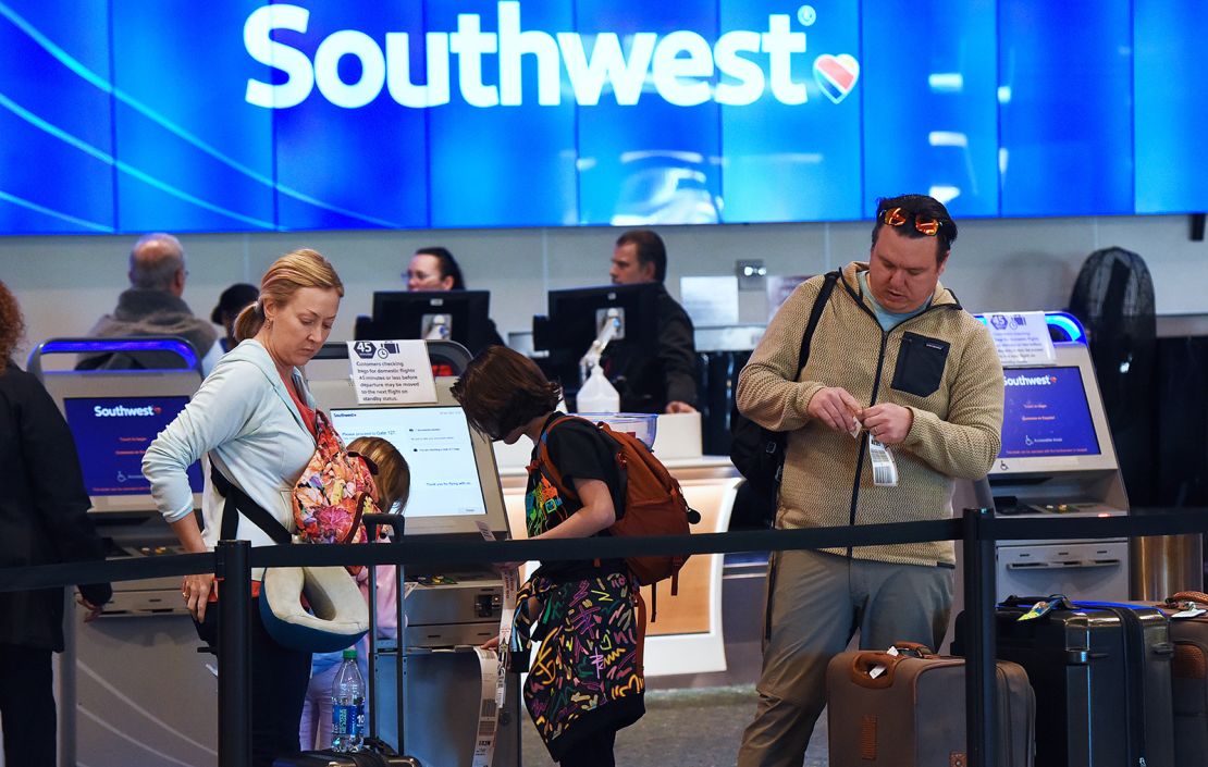 Travelers tag their bags at Orlando International Airport on December 28, 2022.