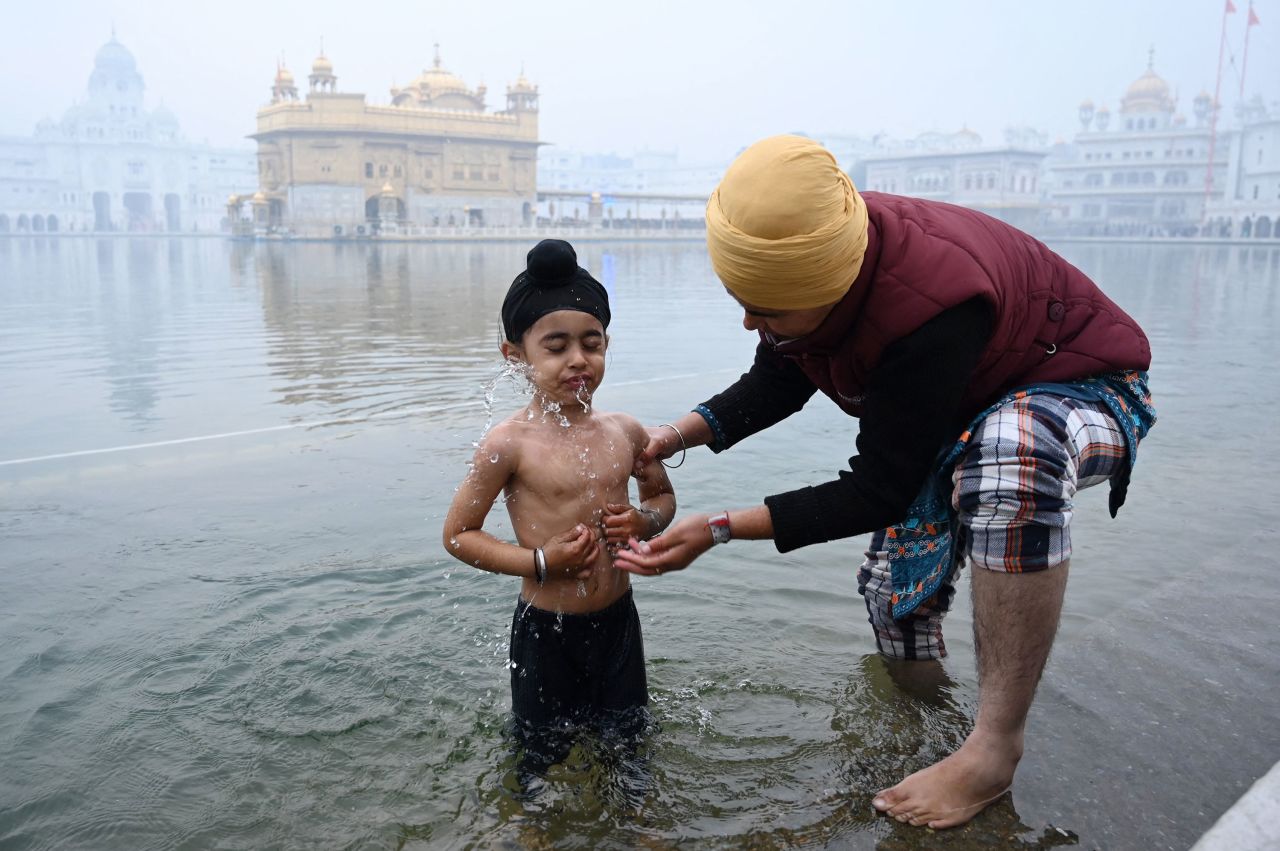 A young Sikh devotee takes a bath in the holy Sarovar (pool) at the Golden Temple in Amritsar, India, on Thursday, December 29. The occasion was the birth anniversary celebrations of Guru Gobind Singh.