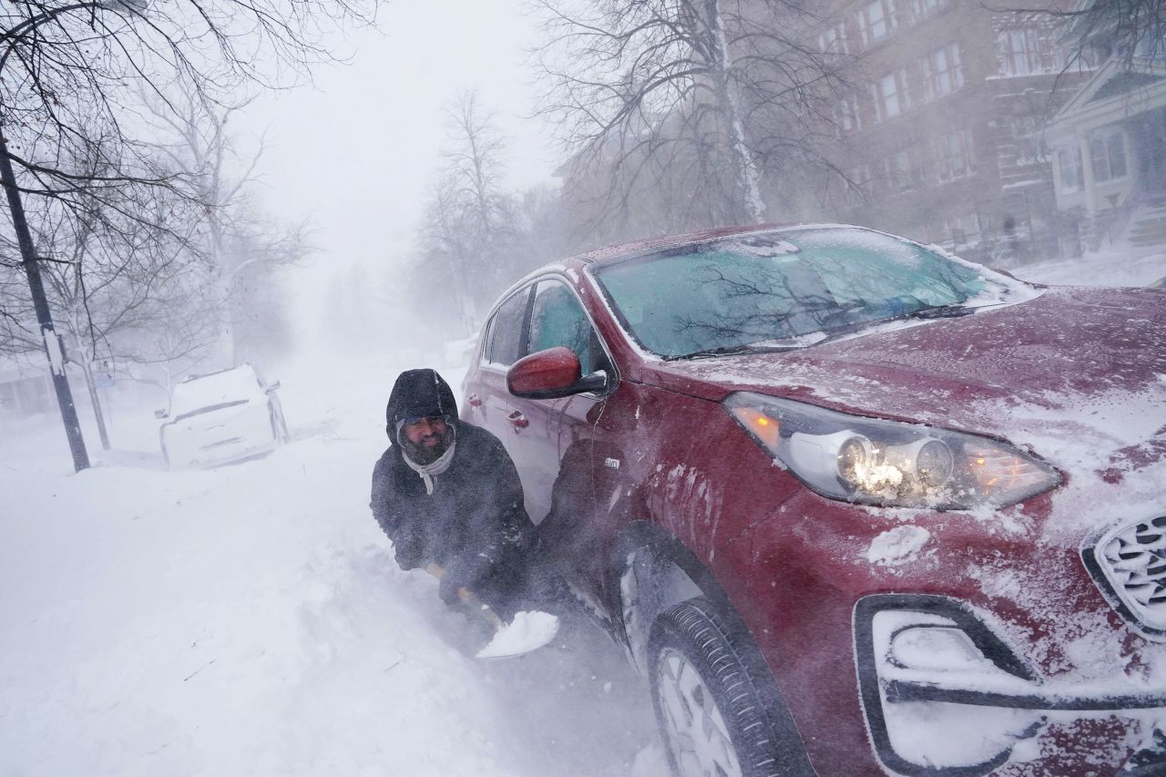 Gamaliel Vega tries to dig out his car from heavy snow in Buffalo, New York, on Saturday, December 24. He was trying to help rescue his cousin, who had lost power and heat with a baby at home across town.
