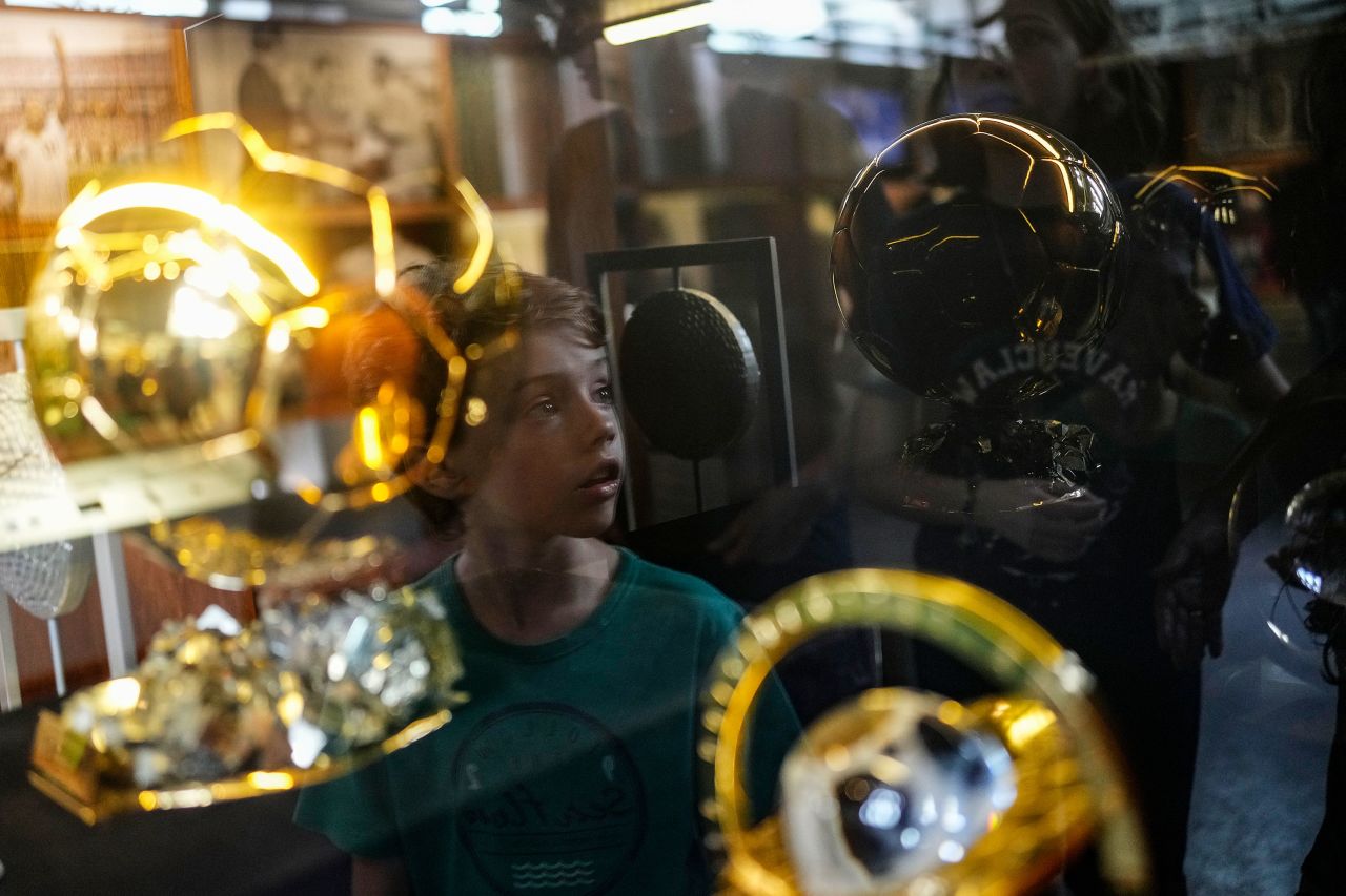 A boy is reflected on a glass case as he tours the Pelé Museum in Santos, Brazil, on Monday, December 26. Pelé, the Brazilian soccer star who became a global icon, <a href="https://www.cnn.com/2022/12/29/football/gallery/pele-life-in-pictures/index.html" target="_blank">died Thursday at the age of 82</a>. 