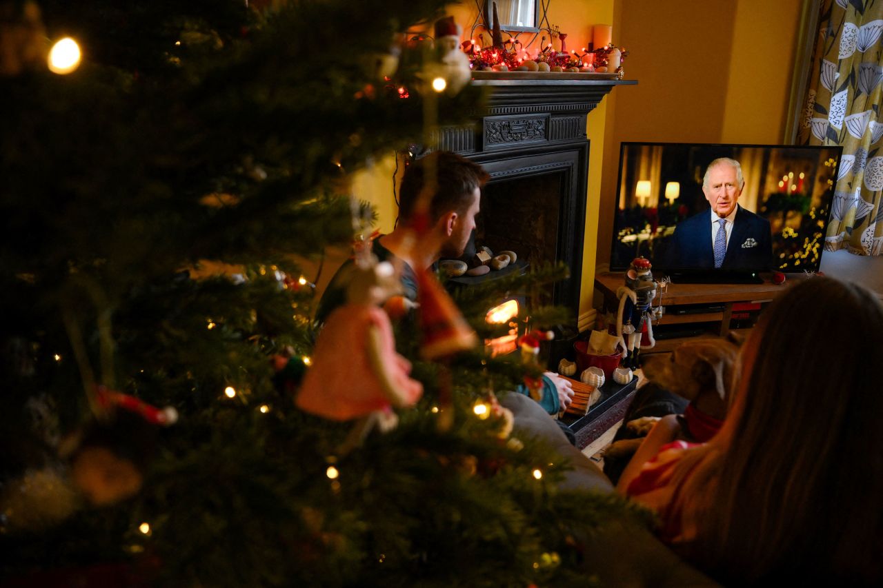 A family sits in a living room in Liverpool, England, as they watch Britain's King Charles III deliver <a href="https://www.cnn.com/2022/12/25/uk/king-charles-christmas-message-intl-gbr/index.html" target="_blank">his first Christmas Day message</a> on Sunday, December 25. The King paid a heartfelt tribute to his mother, the late Queen Elizabeth II, during the broadcast.