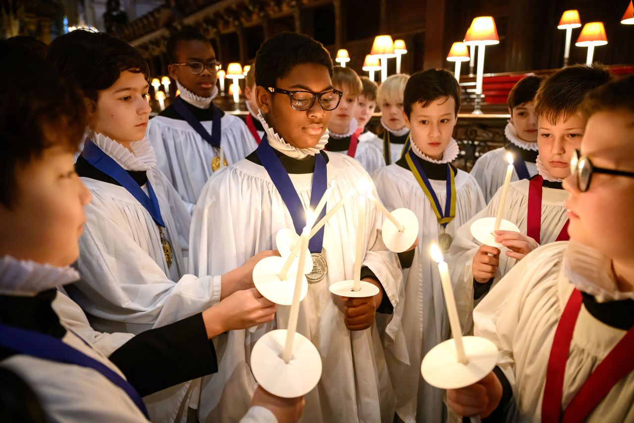 Members of the St Paul's Cathedral Choir light their candles in London on Friday, December 23. They were preparing for a busy program of Advent and Christmas services.
