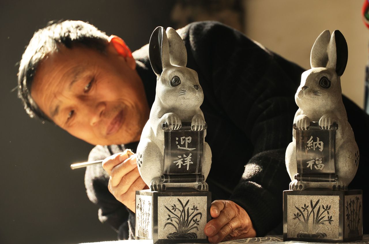 A craftsman works on stone-carved sculptures of rabbits in Yuncheng, China, on Monday, December 26. Chinese New Year begins January 22, and this will be the Year of the Rabbit.