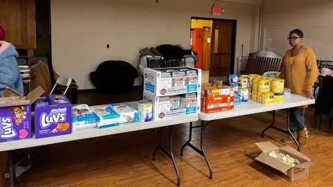 Vivian Robinson (right) stands with necessities and nonperishables for the more than 100 Buffalo residents she and her husband housed during a blizzard.