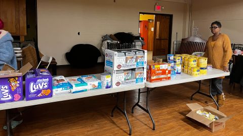 Vivian Robinson (right) stands with necessities and nonperishables for the more than 100 Buffalo residents she and her husband housed during a blizzard. 