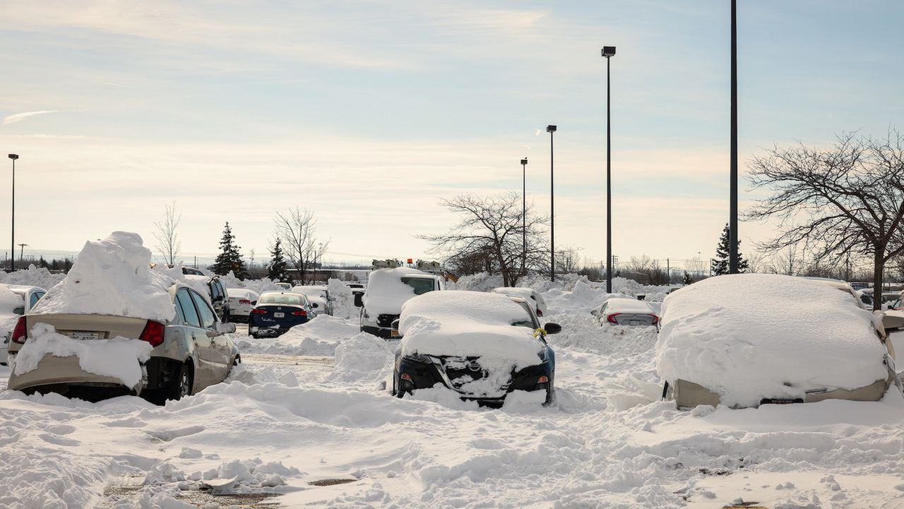 Abandoned cars are piled in snow after being towed to a parking lot following a winter storm in Buffalo, New York. 