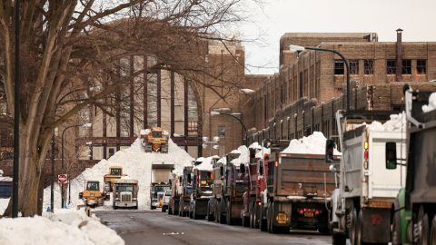 Trucks line up to unload snow in front of Buffalo's central terminal. 