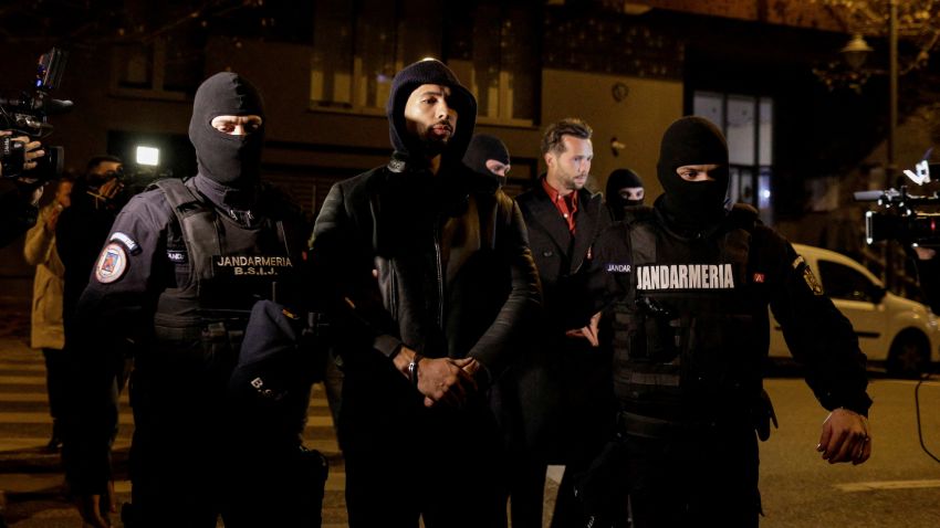 Andrew Tate and Tristan Tate are escorted by police officers outside the headquarters of the Directorate for Investigating Organized Crime and Terrorism in Bucharest (DIICOT) after being detained for 24 hours, in Bucharest, Romania, December 29, 2022.  Inquam Photos/Octav Ganea via REUTERS ATTENTION EDITORS - THIS IMAGE WAS PROVIDED BY A THIRD PARTY. ROMANIA OUT. NO COMMERCIAL OR EDITORIAL SALES IN ROMANIA     TPX IMAGES OF THE DAY     