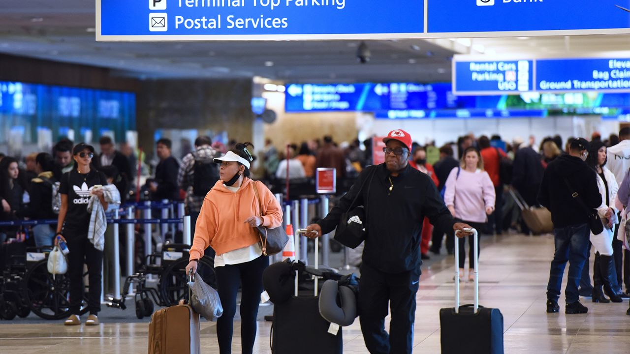 Travelers make their way through Orlando International Airport on Wednesday, December 28, which saw 66 cancellations that day.