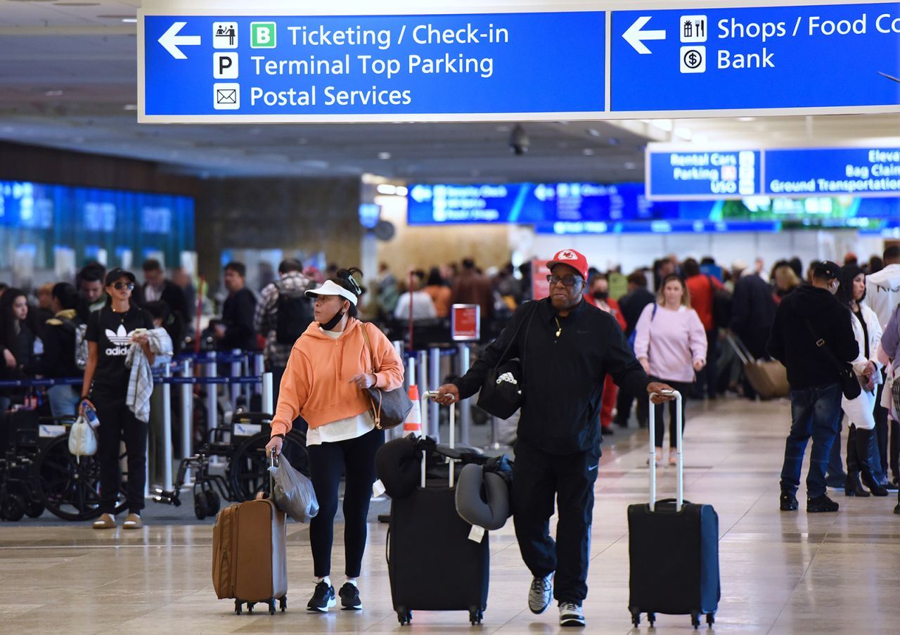 Travelers make their way through Orlando International Airport on Wednesday, December 28, which saw 66 cancellations that day.