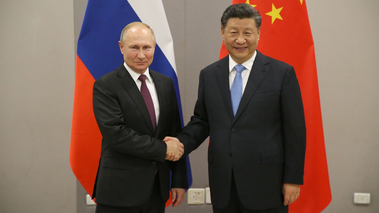 Russian President Vladimir Putin (L) greets Chinese President Xi Jinping (R) during their bilateral meeting on November 13, 2019 in Brasilia, Brazil. 