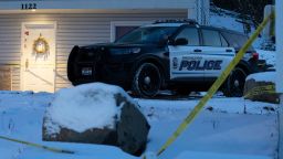 A Moscow police officer stands guard in his vehicle, Tuesday, Nov. 29, 2022, at the home where four University of Idaho students were found dead on Nov. 13, 2022 in Moscow, Idaho. The university will be holding a system-wide vigil on Wednesday evening, Nov. 30, 2022, in memory of the students, as investigators continue to look for a suspect and motive in the killings. (AP Photo/Ted S. Warren)