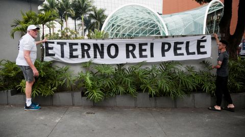 Fans hang a banner reading "Eternal king Pelé" outside the Albert Einstein Hospital where Brazilian soccer legend Pelé was hospitalized before his death in Sao Paulo, Brazil, December 29, 2022.