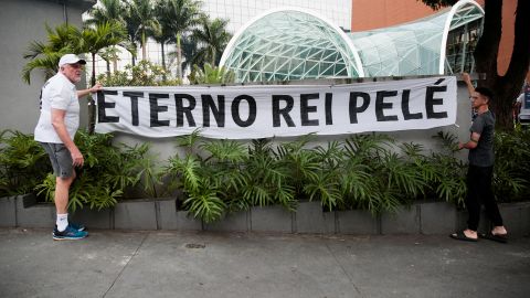 Fans hang a banner reading "Eternal king Pelé" outside the Albert Einstein Hospital where Brazilian soccer legend Pelé was hospitalized before his death in Sao Paulo, Brazil, December 29, 2022. 