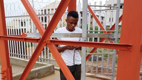 Echezona at work, installing electrical connections for a telecommunications company's floodlights in Anambra State, Nigeria.