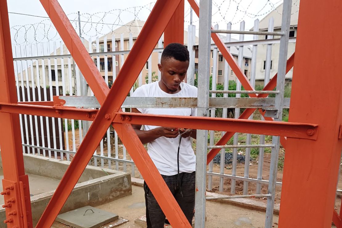 Echezona at work, installing electrical connections for a telecommunications company's floodlights in Anambra State, Nigeria.